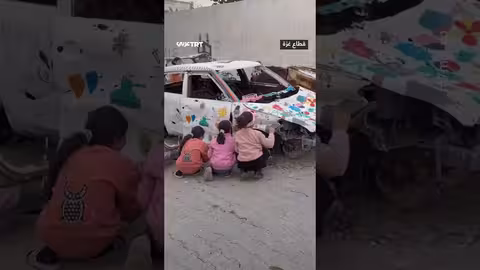 أطفال غزة يحولون سيارة مدمرة إلى عمل فني