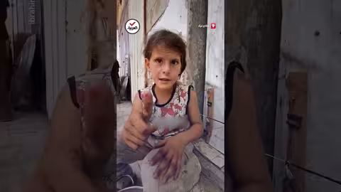 طفلة تبكي في غزة وهي تحمل وعاءً فارغاً في تكية خيرية
